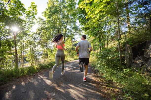 istock Two people running in park at sunset. 1266422143