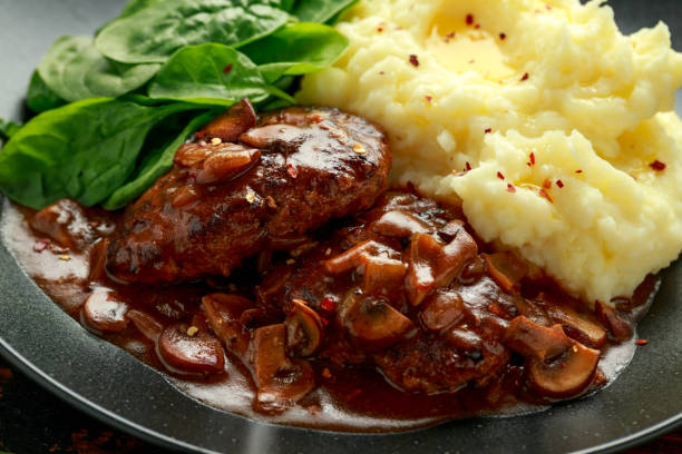 istock Salisbury Steak with mushroom gravy, mashed potatoes and spinach 1266422146