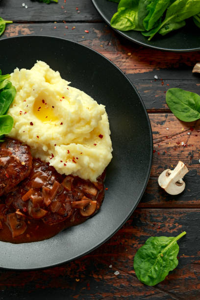 istock Salisbury Steak with mushroom gravy, mashed potatoes and spinach 1266422160