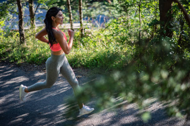 istock Fit woman running at park. 1266422187