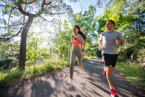 istock Two people running in park at sunset. 1266422274