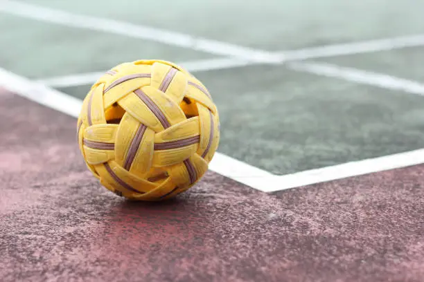 Photo of Close up Sepak takraw or Rattan ball in outdoor field with copy space.