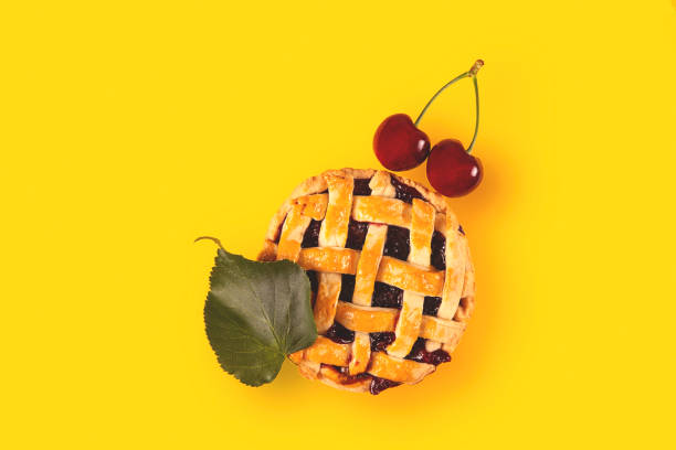 istock Cherry mini pie with ripe cherries on a bright yellow background 1266427858
