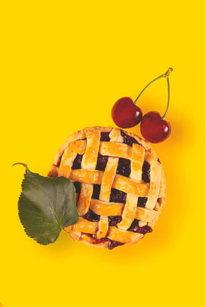 istock Cherry mini pie with ripe cherries on a bright yellow background 1266427875