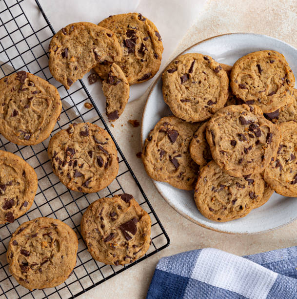 Overhead of Chocolate Chip Cookies Overhead of chocolate chip cookies on a plate and cooling rack chocolate chip cookie top view stock pictures, royalty-free photos & images