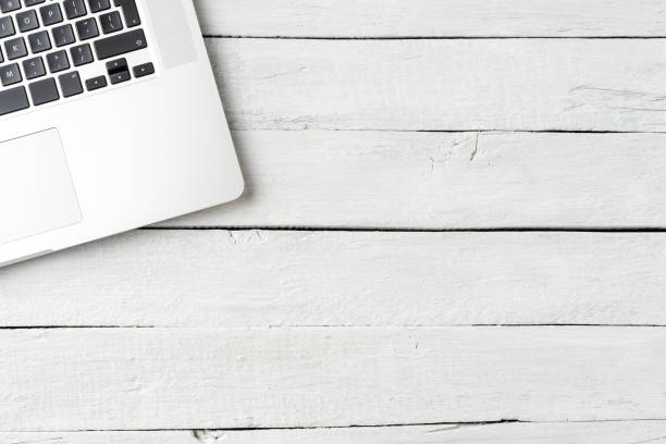istock Modern laptop on white wooden background. Office desktop. Top view 1266432470