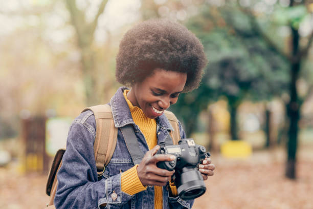 istock Young woman with photo camera 1266434963