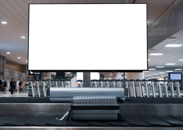 istock LCD Blank billboard at conveyor belt luggage in airport. Wide screen for cutomer text information advertise about tourism transport business etc. advertising mock up empty in metropolitan 1266437310