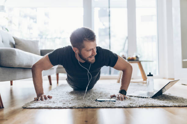 istock Handsome man working out at home 1266442854