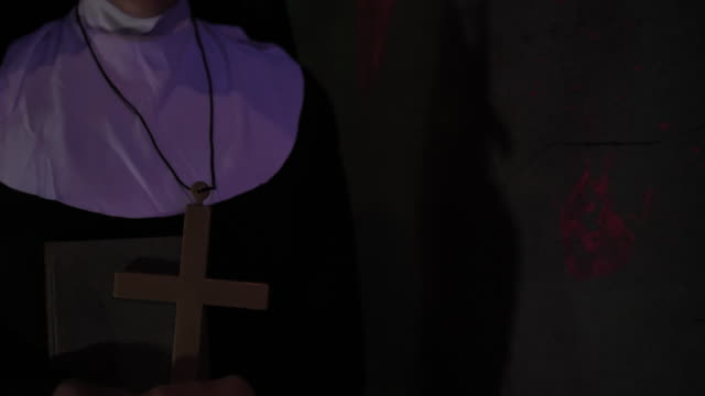 Nun holding  Religious Cross in her hand