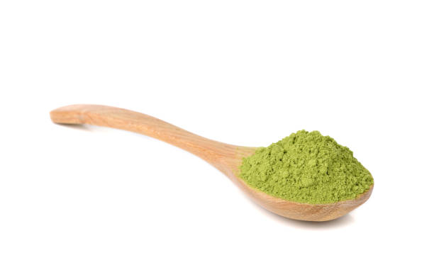 istock Matcha green tea powdered with wooden spoon isolated on white 1266443682