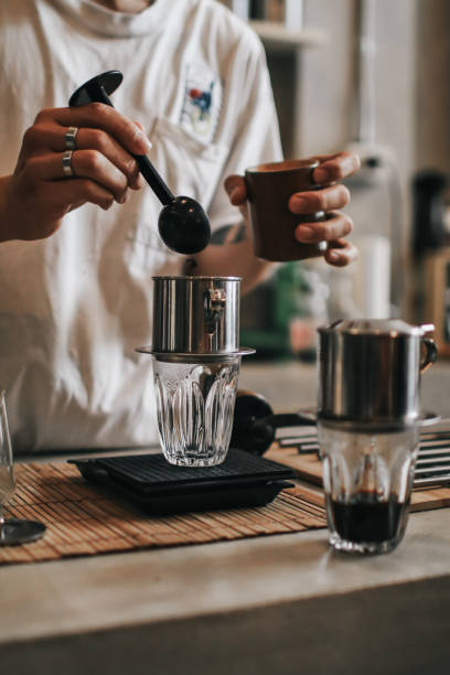 istock Close up barista carefully measuring coffee grains on a digital scale while preparing a cup of coffee 1266444022