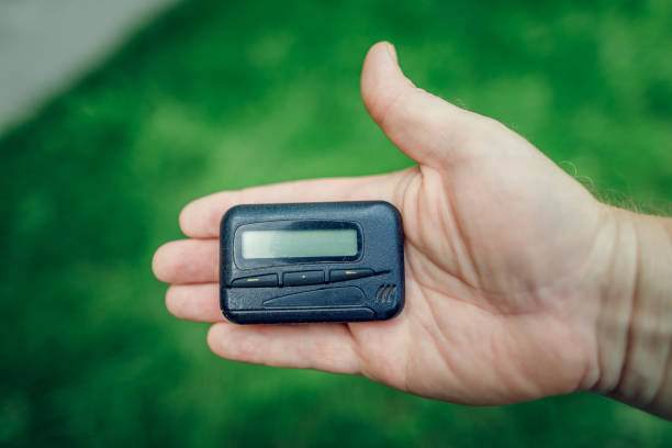 istock pager, old vintage beeper. pager in hand 1266444034