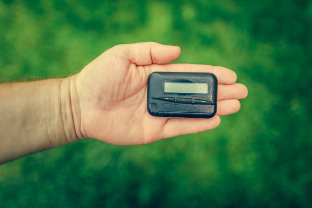 istock pager, old vintage beeper. pager in hand 1266444058