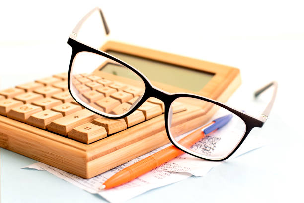 istock calculator glasses and pen 1266444185