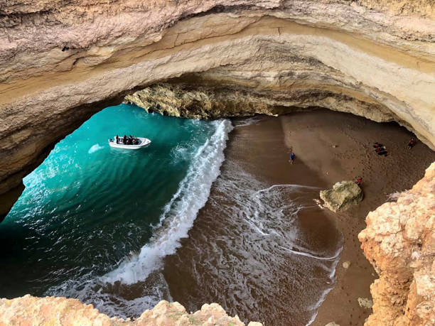 istock a cave on the beach with a boat 1266445279