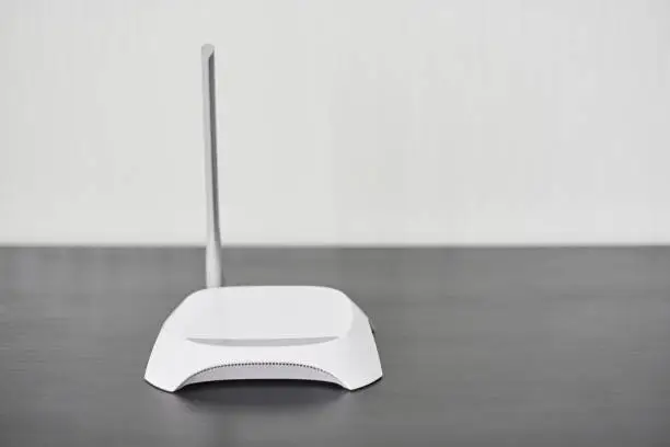 WiFi wireless router, copy space. Wireless device for broadband Wi-Fi 6 network in office or home. Secure dual band wireless LAN channel with encryption and firewall.