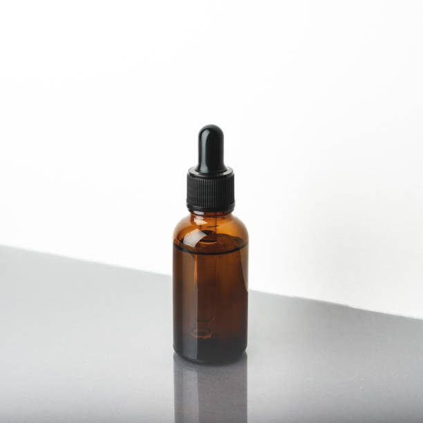 istock A glass dropper bottle on the beige background. 1266446311