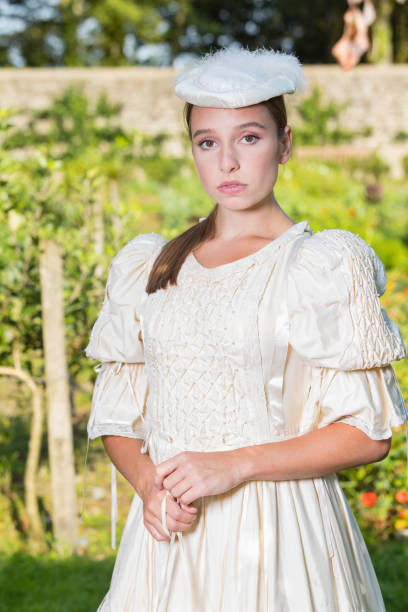 istock Victorian lady promenading in the gardens 1266449619