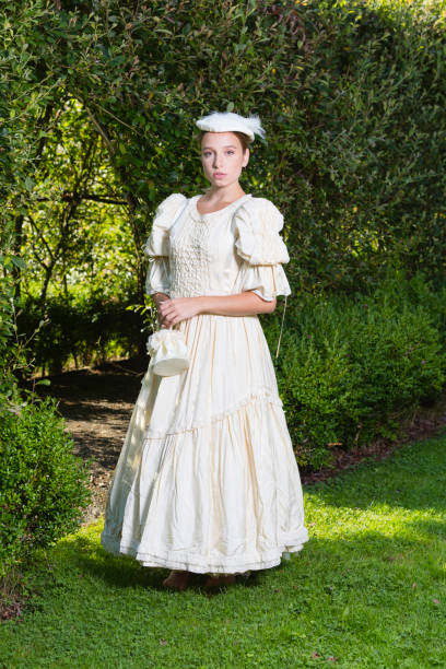 istock Victorian lady promenading in the gardens 1266449726