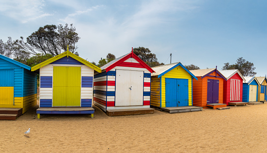 A row of colourful multi-coloured wooden beach huts at Brighton Beach, Melbourne, Victoria State, Australia