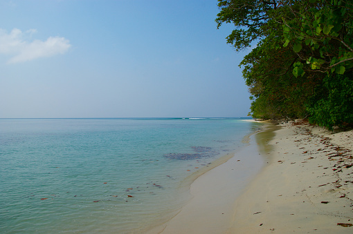 tropical beach. calm water and white sand on a tropical island