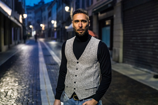 Portrait of Well Dressed Young Man on Streets of Italian Town in the Evening.