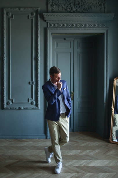 istock Handsome well-dressed man in jacket in a room 1266455419