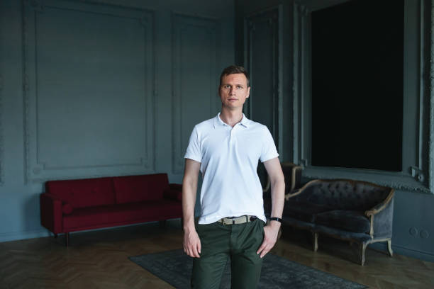 istock Handsome well-dressed man in white shirt in interior 1266455422