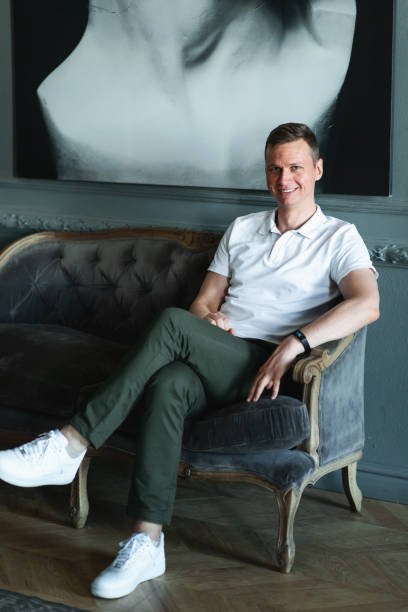 istock Handsome well-dressed man in white shirt in interior 1266455426