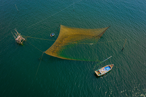 Drone view fisherman is pulling fishing trap on the sea - Cam Ranh, Khanh Hoa province, Vietnam.