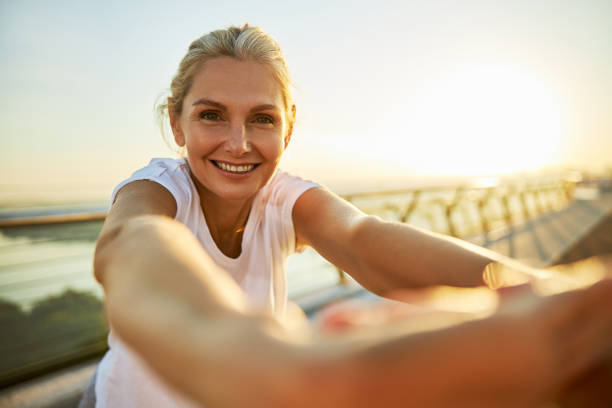 istock Joyful woman doing exercise on the street 1266458762