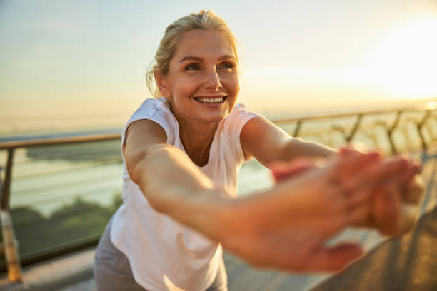 istock Cheerful woman doing exercise on the street 1266458763