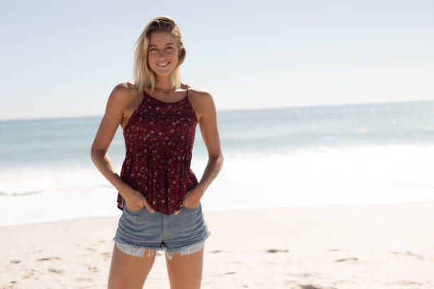istock Young Caucasian woman smiling on the beach 1266460089