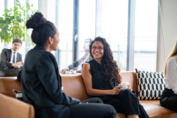 istock Hispanic Businesswomen Conversing During Office Coffee Break 1266460780