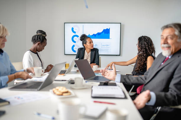 istock Corporate Executives in Board Room Talking Before Meeting 1266460880
