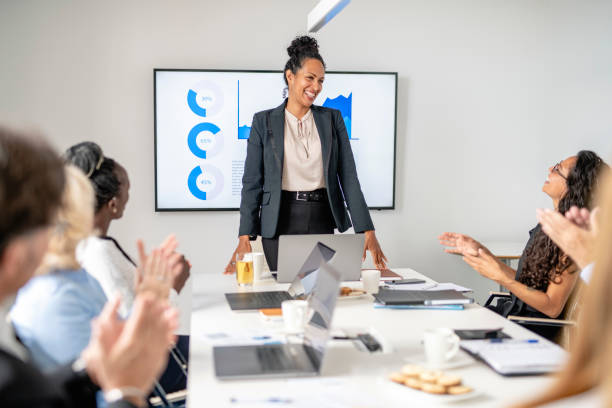 istock Multi-Ethnic Executive Team Applauding Female CEO in Meeting 1266461202