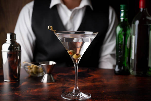 istock bartender serving martini in glass at bar 1266464995