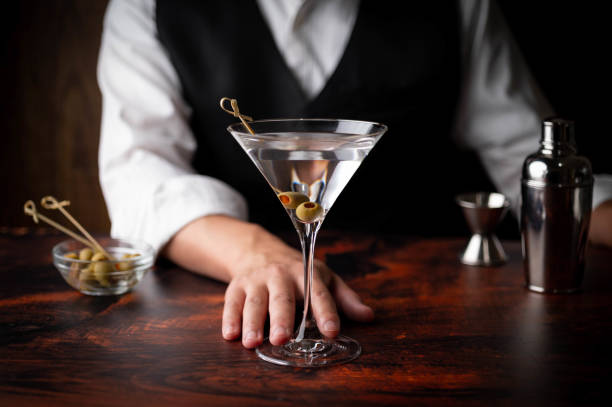 istock bartender serving martini in glass at bar 1266464999