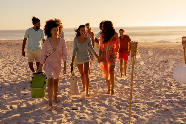 istock Mixed race friends group walking on beach 1266465546