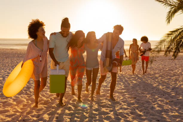 istock Mixed race friends group walking on beach 1266465634
