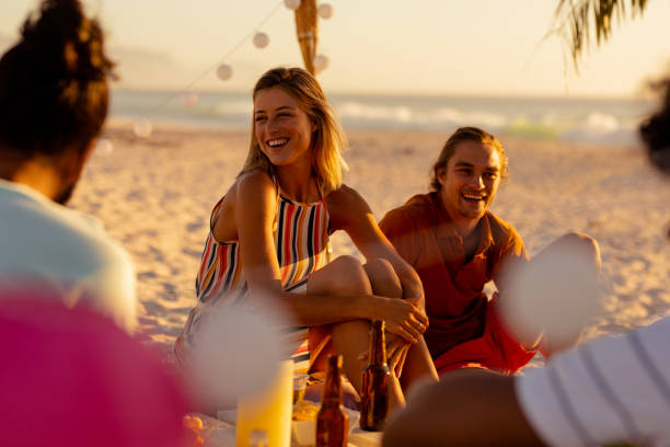 istock Mixed race friends group having fun on beach 1266465639