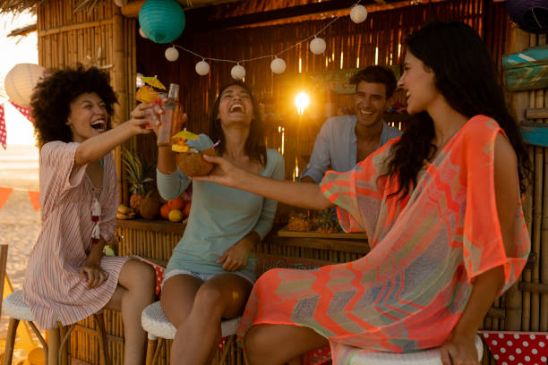 istock Mixed race friends having fun on beach 1266465939