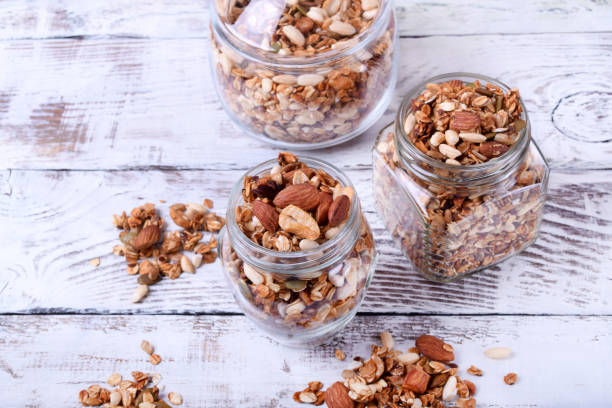istock Granola with nuts in glass jars 1266468728
