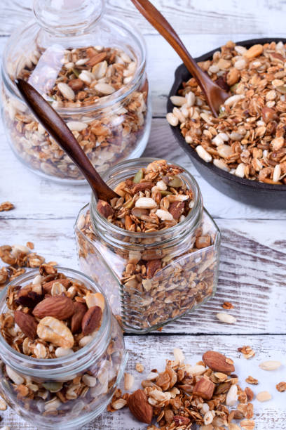 istock Granola with nuts in glass jars 1266468736