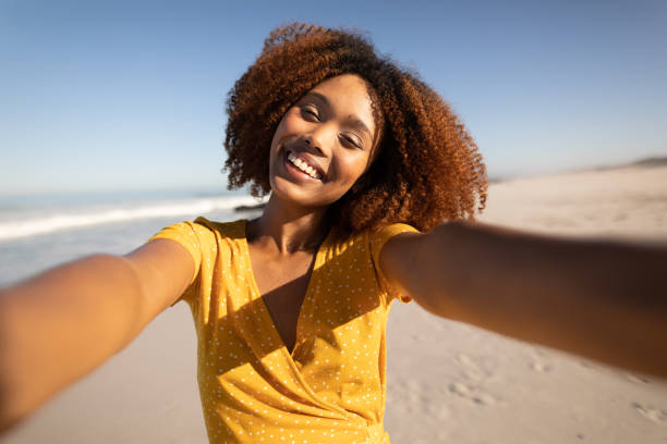 istock Mixed race woman enjoying her time on the beach 1266469008