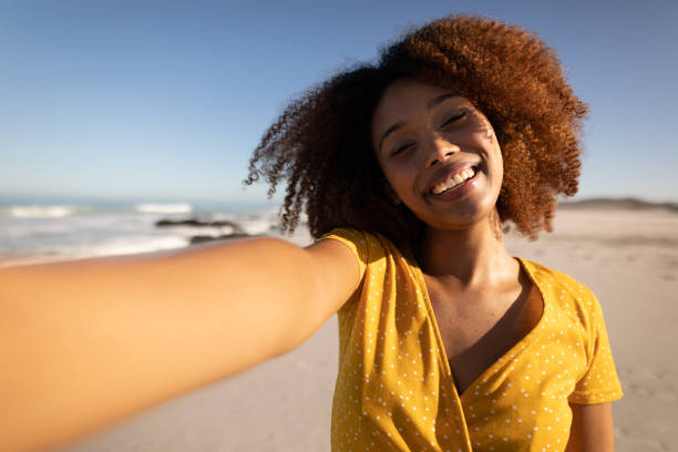 istock Mixed race woman enjoying her time on the beach 1266469540