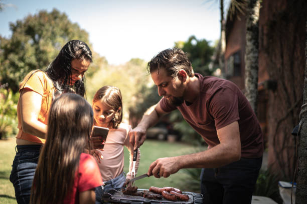 istock Family doing a barbecue together in the backyard 1266469758