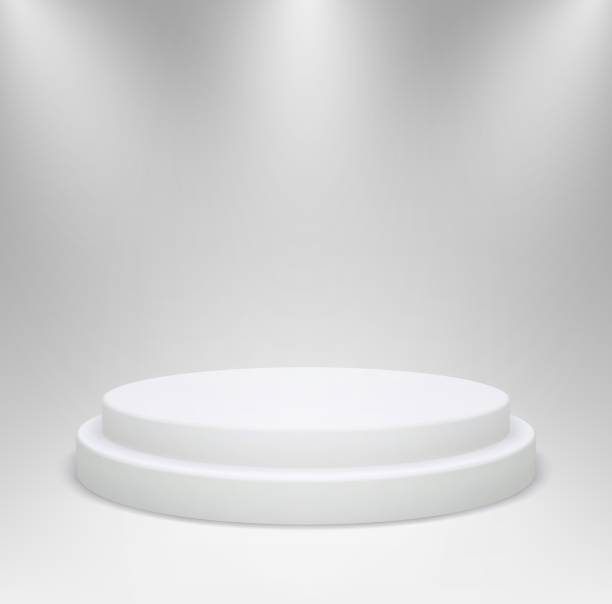 istock Realistic white round podium in studio lighting. 3d pedestal or platform for product showcase on a gray background. 1266471250