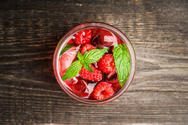 istock Raspberry and mint cocktail in glass on the rustic background 1266473267
